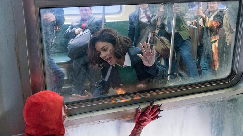 Vanessa Hudgens as Emily Locke, looking at a superhero through a subway window in Powerless.
