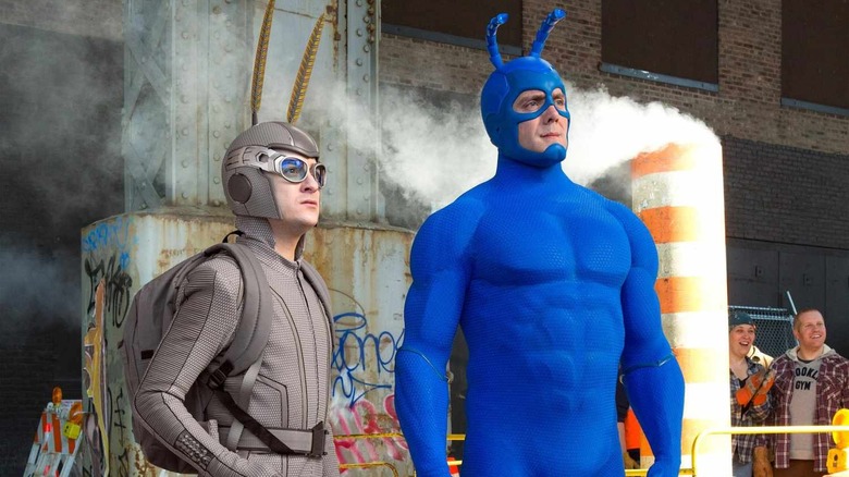 Griffin Newman as Arthur Everest and Peter Serafinowicz as The Tick, standing near a construction area in The Tick.