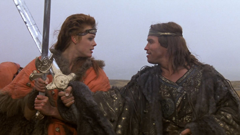 Brigette Nielsen as Red Sonja crossing swords with Arnold Schwarzenegger as Conan