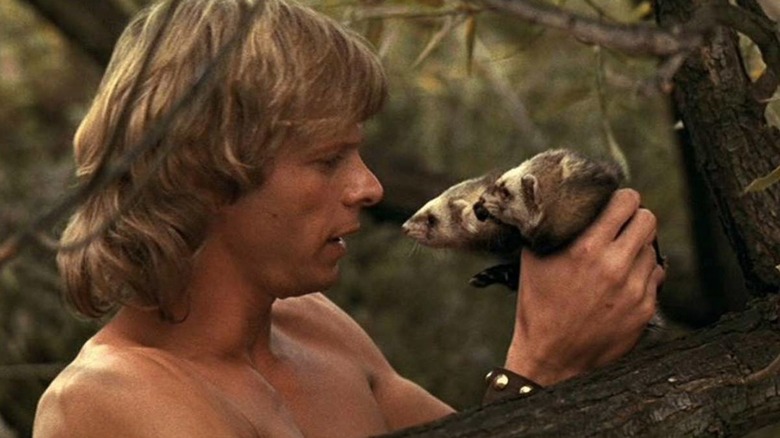 Dar (Marc Singer) holds two wiggly ferrets, Podo and Kodo