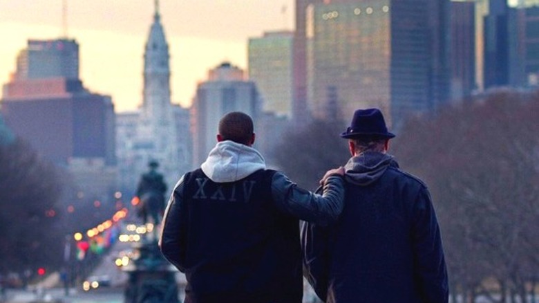Adonis and Rocky standing on the steps