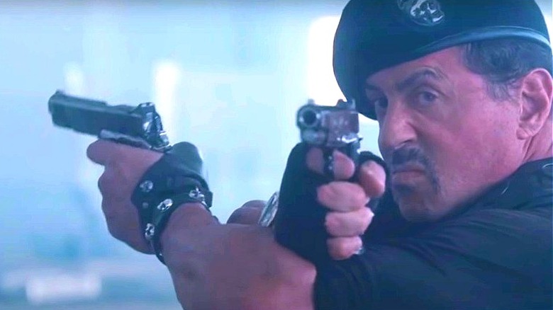 Barney Ross wielding two guns