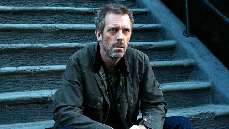Dr. House sitting on concrete steps on House, M.D.