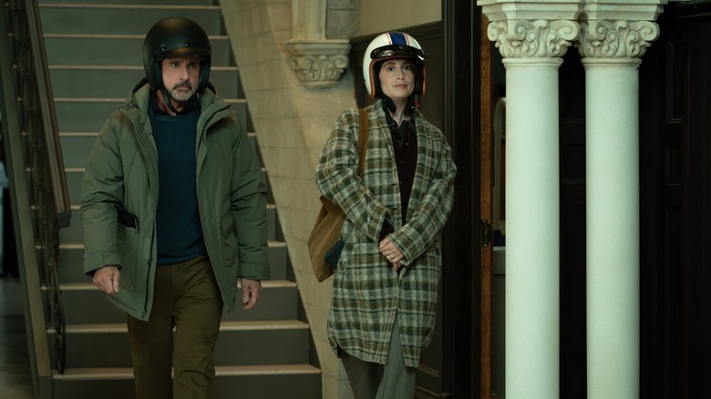 Greg and Katie wearing helmets in a Ludlow hallway on Rooster