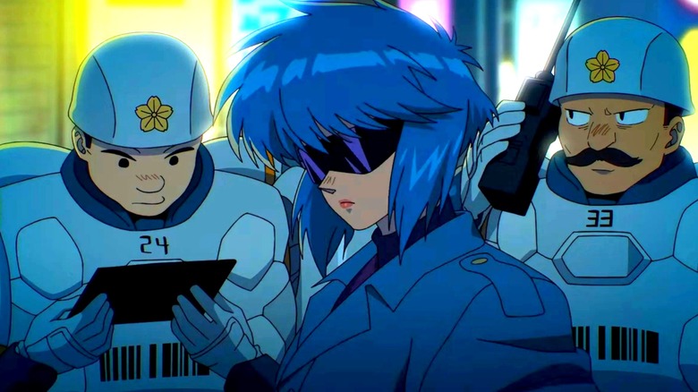 Motoko Kusanagi looking hella cool walking by some cops in The Ghost in the Shell