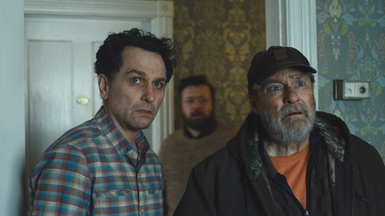 Mayor Loftis and Wyck looking at something in a haunted hotel room on Widow's Bay