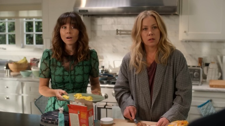 Linda Cardellini as Judy Hale and Christina Applegate as Jen Harding standing in a kitchen on Dead to Me