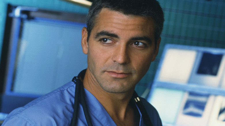 George Clooney as Doug Ross, standing in an operating theater on E.R.