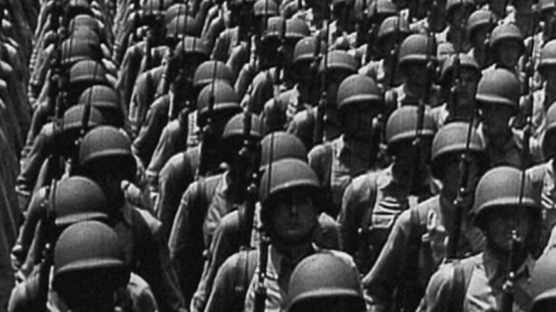 American soldiers stand in formation with fixed bayonets in Five Came Back
