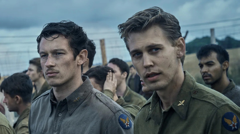 Major Bucky Egan (Callum Turner) stands next to Major Buck Cleven (Austin Butler) in a prison camp in Masters of the Air