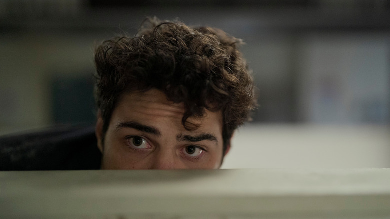 Owen Hendricks (Noah Centineo) peeking over a cubical on The Recruit