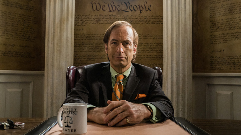 Bob Odenkirk as Saul Goodman, sitting at his desk on Better Call Saul