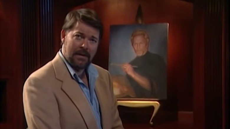 Jonathan Frakes sitting in front of a portrait on Beyond Belief