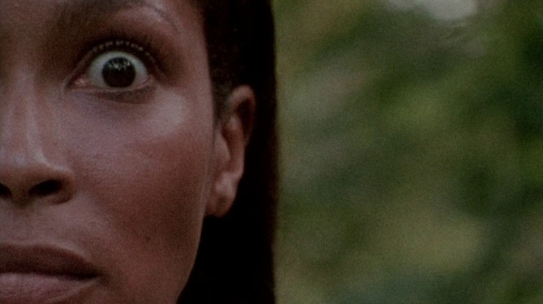 Half-face of Ganja Meda (Marlene Clark) looking scared in Ganja & Hess (1973).