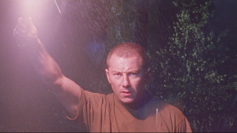 A soldier with a flare in Dog Soldiers