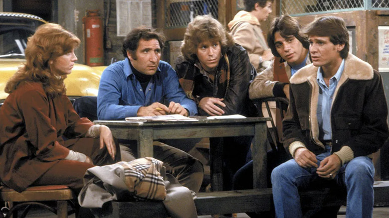 Marilu Henner as Elaine O'Connor Nardo, Judd Hirsch as Alex Reiger, Jeff Conaway as Bobby Wheeler, Tony Danza as Anthony Mark "Tony" Banta, and Randall Carver as John Burns sitting on a bench together in Taxi