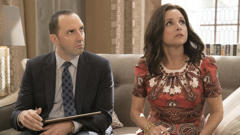 Tony Hale as Gary Walsh wearing a suit and Julia Louis-Dreyfus as Selina Meyer wearing a dress while sitting on a couch while looking confused in VEEP