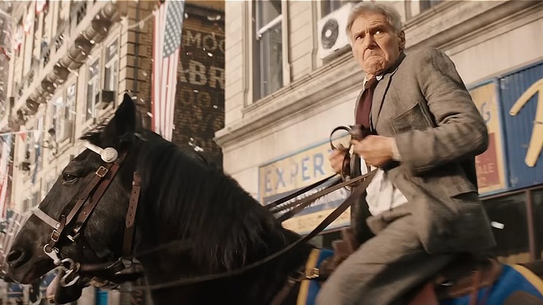 Indiana Jones races through a parade on horseback