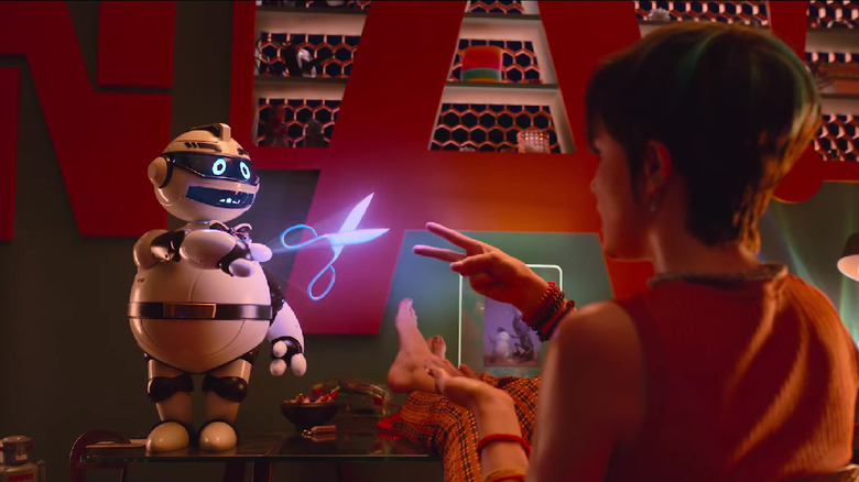 A droid plays Rock Paper, Scissors with a human woman in Bigbug