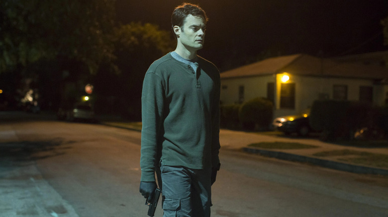 Barry (Bill Hader) walks on street while holding a gun