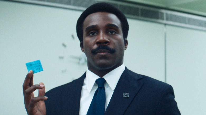 Tramell Tillman as Mr. Milchick holding a note in Severance