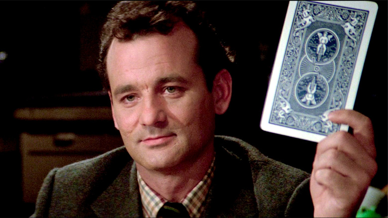Peter Venkman holds up an enormous playing card