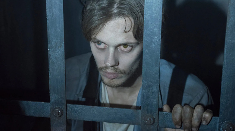 The Kid (Bill Skarsgard) peers through prison bars on Castle Rock