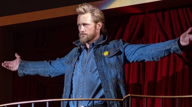 Randall Flagg (Alexander Skarsgård) spreads his arms in The Stand