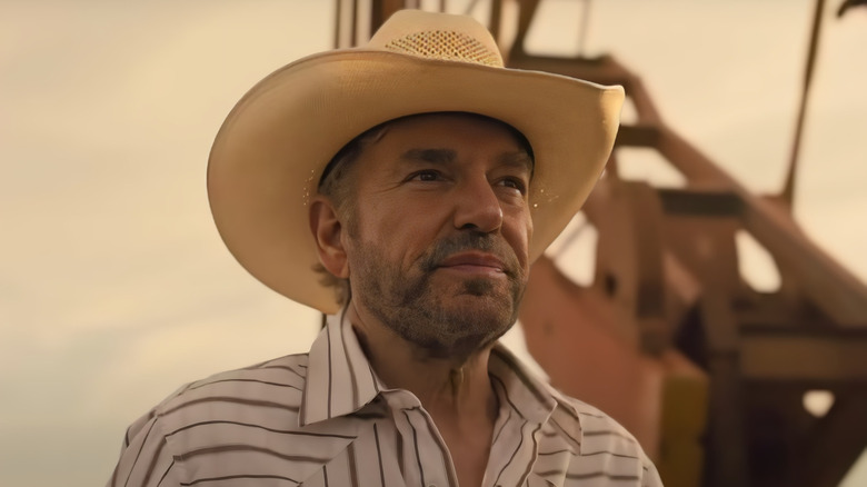 Billy Bob Thornton's Tommy Norris, wearing a hat and standing on an oil rig