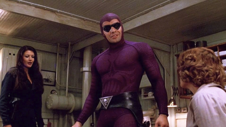 The Phantom standing in a room with two women in The Phantom