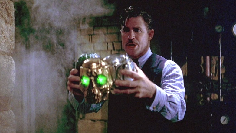 Xander Drax holding a magical trio of skulls in The Phantom