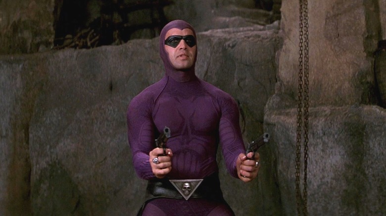 The Phantom in a cave holding two guns in The Phantom