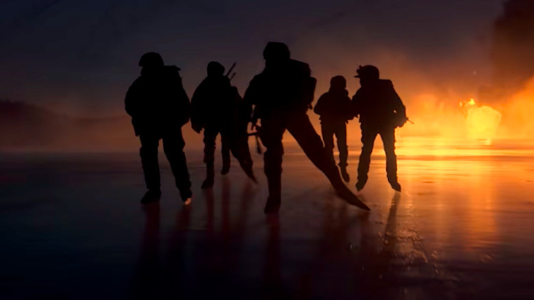 A team of soldiers cross the ice in ice skates