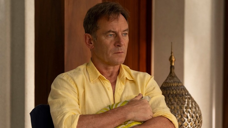 Jason Isaacs as Timothy Ratliff, holding a pillow on The White Lotus