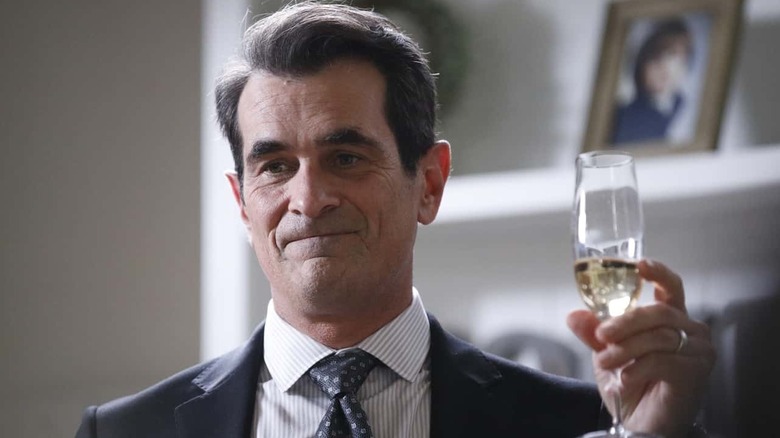 Ty Burrell as Phil Dunphy, raising a glass on Modern Family
