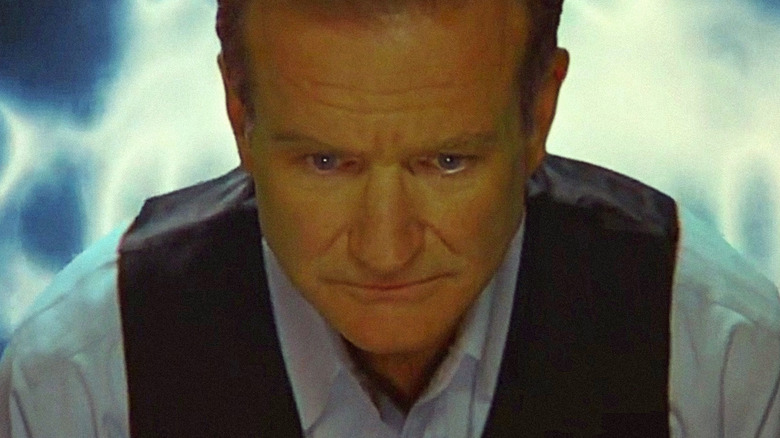 Robin Williams' Alan Hakman wearing a black vest and looking serious in The Final Cut