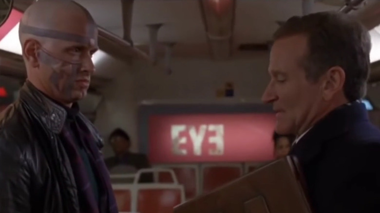 Robin Williams' Alan Hakman looking nervous facing a man with facial tattoos in The Final Cut