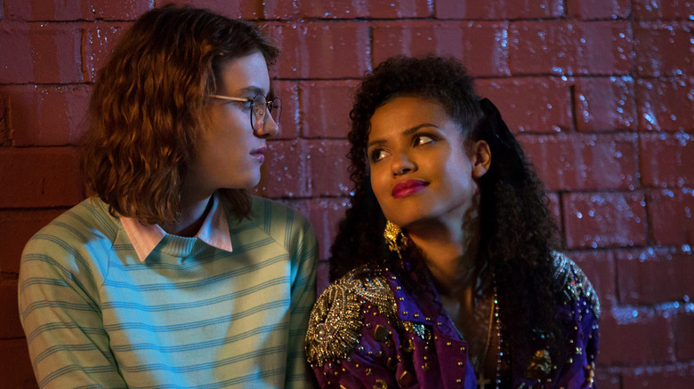 Yorkie and Kelly looking at each other in 80s clothing on San Junipero