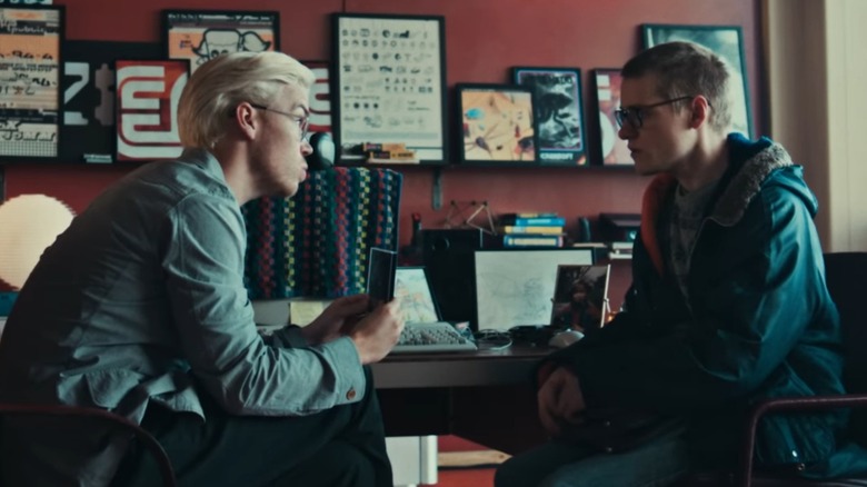 Will Pouler's Colin leans in to show Lewis Gribben's Cameron a floppy disk in Black Mirror