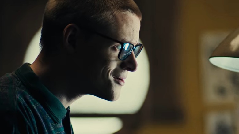Lewis Gribben's Cameron smiles at his computer screen in Black Mirror