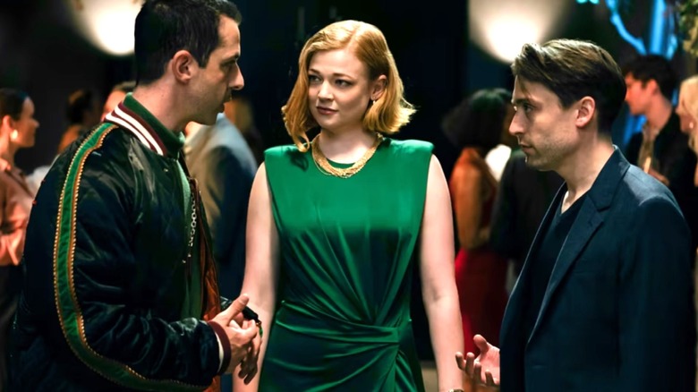 Kendall, Shiv, and Roman talking to each other at a party in Succession