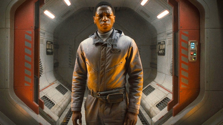 David Jonsson as Andy standing in a hallway In Alien: Romulus