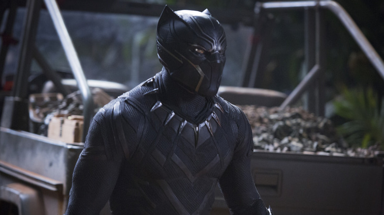 Black Panther standing by a truck in Black Panther