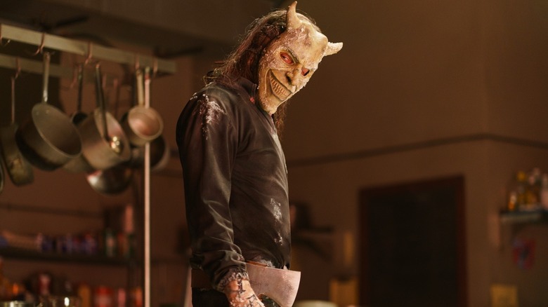 Ethan Hawke as The Grabber holding an ax in the kitchen in Black Phone 2