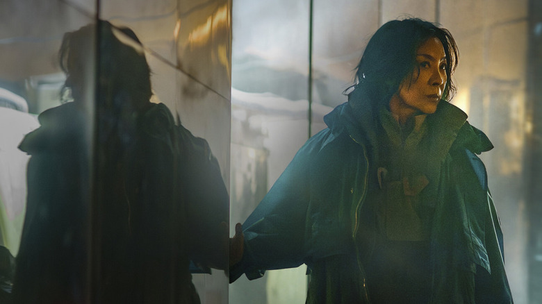 Olwen (MIchelle Yeoh) stands beside her reflection in Blade Runner 2099