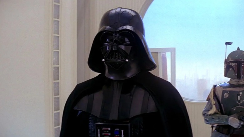 Darth Vader standing with Boba Fett behind him