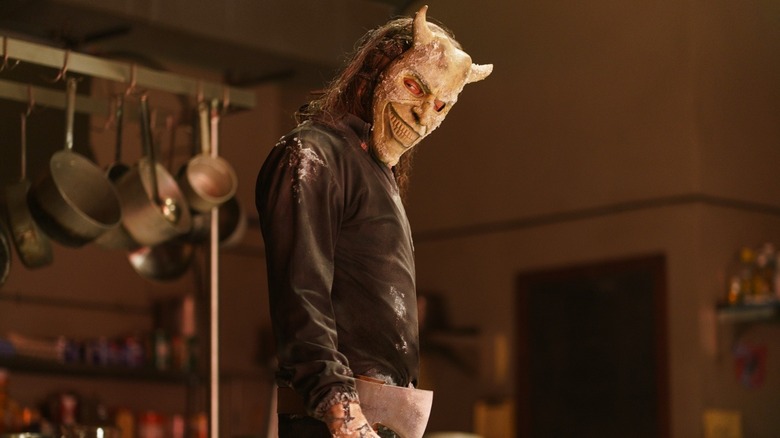 Ethan Hawke as The Grabber holding an ax in the kitchen in Black Phone 2