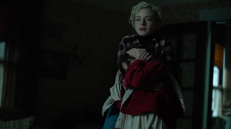 Julia Garner's Charlotte and Matlida Firth's Ginger looking at Blake with fear and concern in Wolf Man (2025)