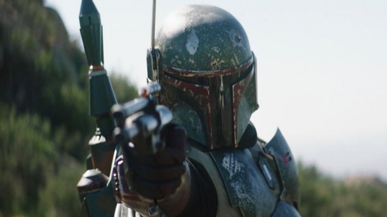 Boba Fett pointing a blaster