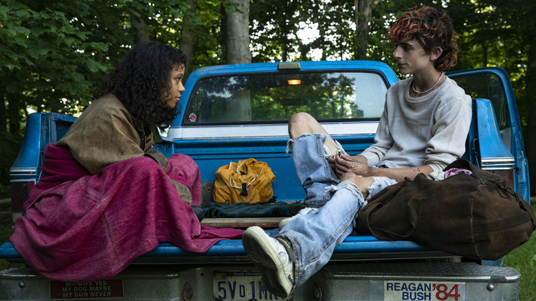 Taylor Russell and Timothée Chalamet sit in the back of a car in Bones & All